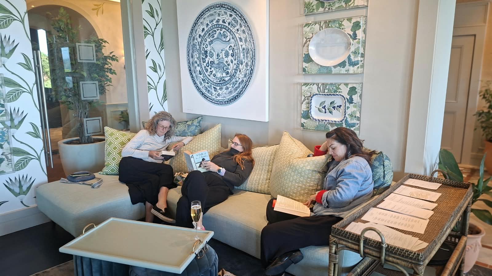 Three readers enjoying books together in a lounge
