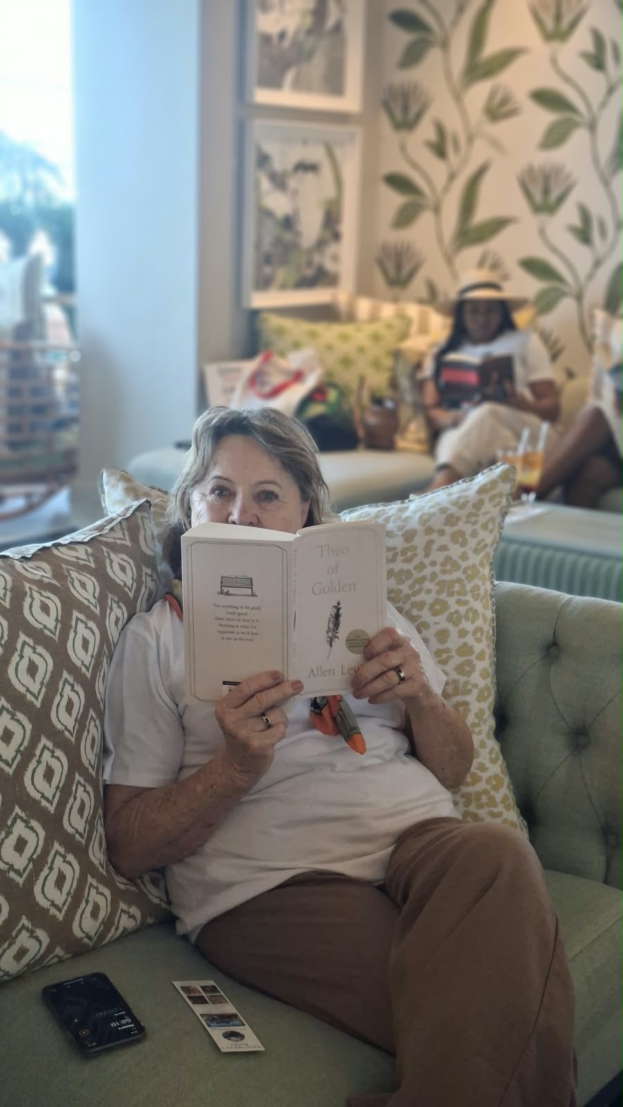 A reader relaxing on a sofa with her book
